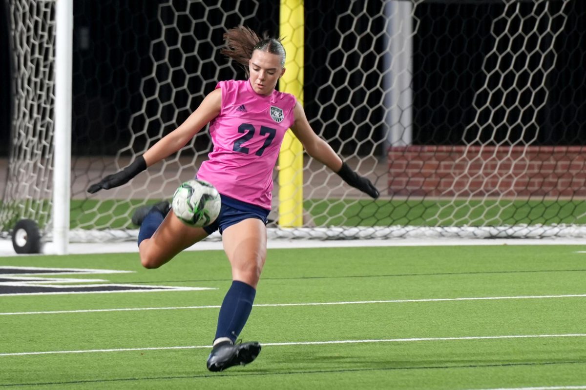 Junior Peyton Smithson punts the ball during the team's final game of the season against A&M Consolidated. Smithson has been a three-year varsity goalkeeper.