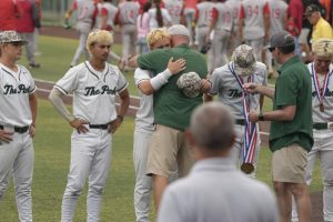 After receiving his state semifinalist medal, senior Nathan Eveler hugs assistant principal Gary Brain. The Panthers ended its season in the State Tournament for the second year in a row.