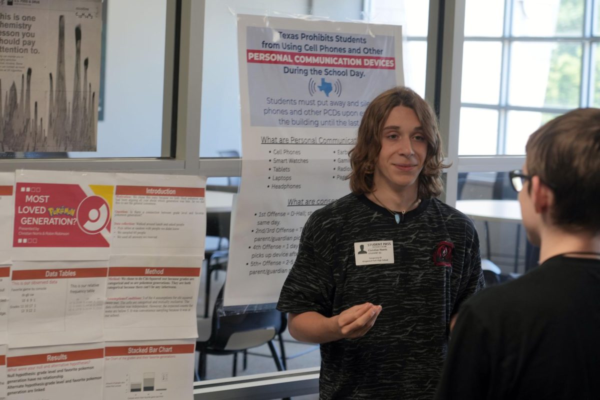 Junior Christian Norris presents his OnRamps stats project to classmates on May 13. He did research on what generation of Pokémon was the best.