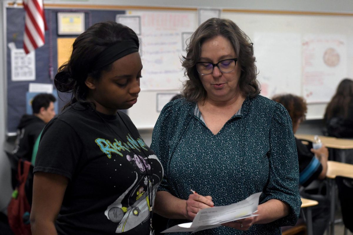 Senior Maria Williams visits with French teacher Beverly Randall during French 2 in May. 