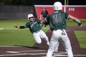 In the seventh inning, senior Landon Coburn slides into home plate to score the second run of the game. The run put the Panthers ahead, before Port Neches-Grove tied the game to go into extra innings.